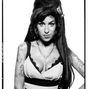 Amy Winehouse by Terry O'Neill, portrait of the singer in a black and white dress