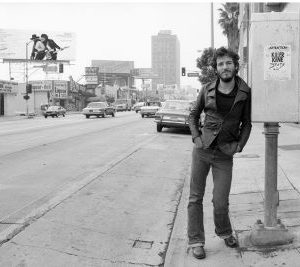 Bruce Springsteen on Sunset Strip by Terry O'Neill, the singer leaing on a post next to the street