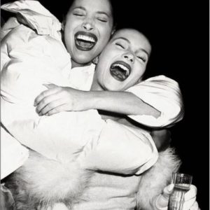Christy Turlington and Kate Moss by Roxanne Lowit, one of the models hugging the other and laughing