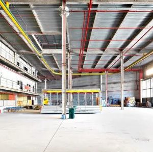 Cidade do Samba II by Massimo Listri, industrial hall with red and yellow iron bars