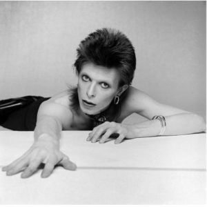 David Bowie II by Terry O'Neill, the singer reaching out towards the camera, topless