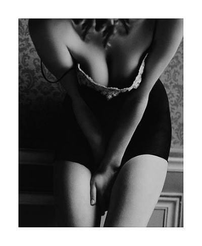 Kate Ashton, Paris 90 by Bruno Bisang, model in short dress bending over and showing her cleavage