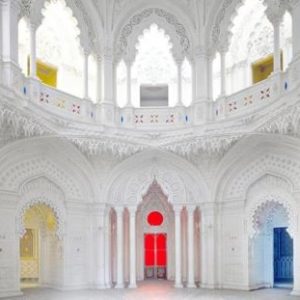 Sammezzano V by Massimo Listri, white room with detailed stucco decor and yellow red and blue light