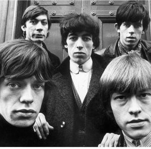 The Rolling Stones by Terry O'Neill, portrait of the band in front of a wooden door