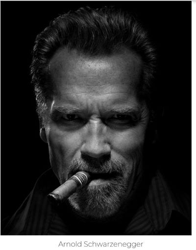 Arnold Schwarzenegger by Tinothy White, black and white portrait of the body builder with a cigar