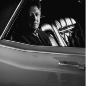Dustin Hoffman by Timothy White, black and white portrait of the actor sitting in a car