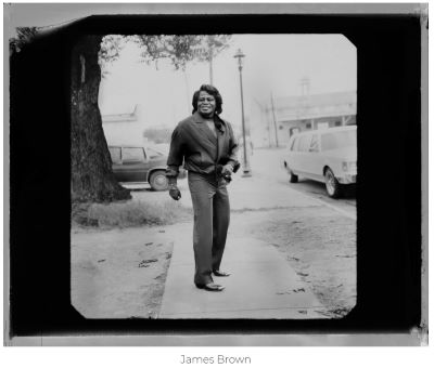 James Brown by Timothy White, the musician on a rural street between cars and a tree