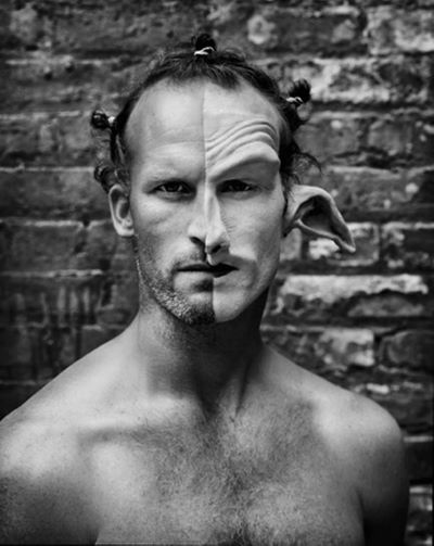 Matthew Barney by Mark Seliger, the artist in front of a brick wall, paritially in makeup for the movie cremaster