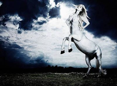 Centaur II by Rankin, white centaur with girl body in front og a stormy sky