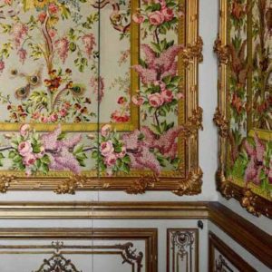Chambre de la Reine by Robert Polidori, white wall with gold stucco and colorful floral decor with 'invisible' servants door