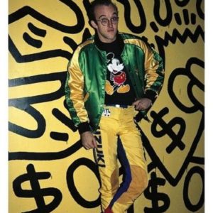 Keith Haring by Roxanne Lowit, the artist in green and yellow tracksuit and mickymouse shirt in front of one of his yellow pieces