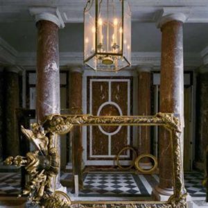 Vestibule, Chateau de Versailles, 1986 by Robert Polidori, red and white marble interior with empty gold frames lying around