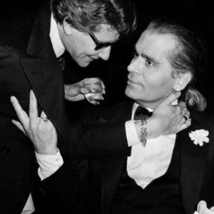 YSL und Karl Lagerfeld by Roxanne Lowit, the two designers in black suits, holding each other