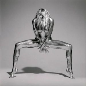 Silvereye by Guido Argentini, silver painted model in godess pose covering herself with her hands