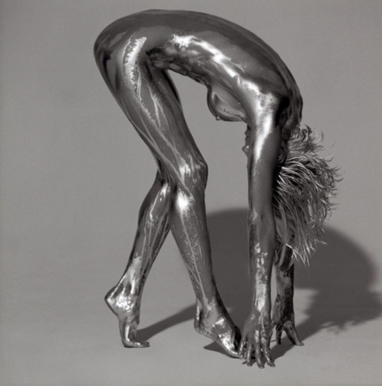 Gaia by Guido Argentini, silver painted model folding over to reach for the ground