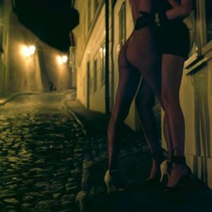 Where duality begins by Guido Argentini, two models in heels making out in a street at night