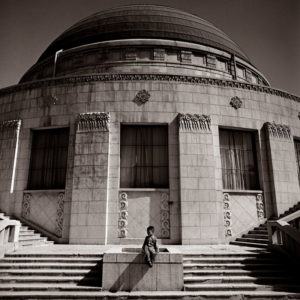 Boy awaiting Parents - Beijing Observatory 1979 by Albert Watson, by sitting on a staircase in front of  a round