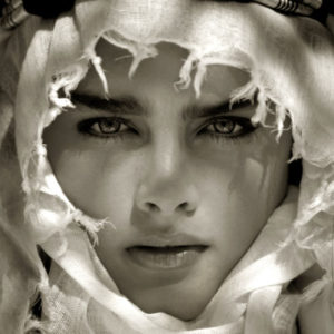 Brooke Shields - Mustique 1981 by Albert Watson, closeup portrait of the model wearing a white headscarf