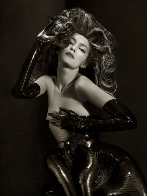 Gigi Hadid - Iris Van Herpen - Gloves by Tableaux - New York City 2019 the model in metallic gown and latex gloves with big hair