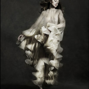 Gigi Hadid - Iris Van Herpen - New York City 2019 by ALbert Watson, the model in a white ruffled cape gown jumping