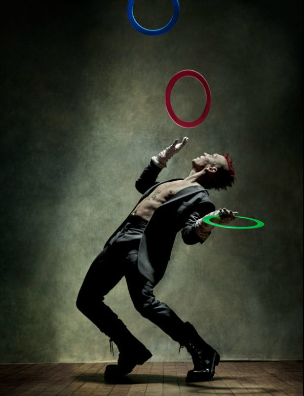 Josh Dean - Zoo Magazine - NYC 2020, mal in a grey suit and red deathhawk juggling colorful rings