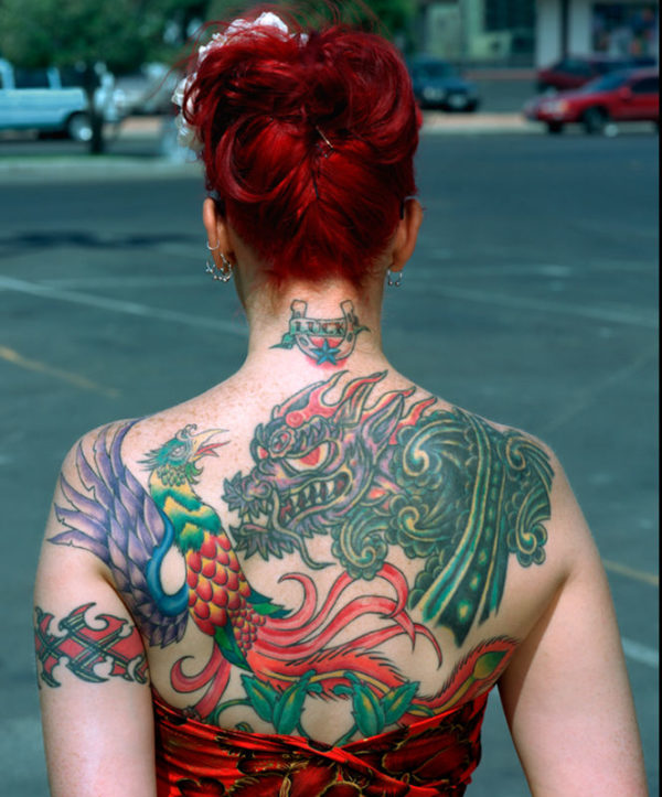 Linda Husjord - Las Vegas 2001, back of a woman with a dragon and bird tattoo on her back, wearing a red dress and updo, standing in a parking lot