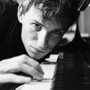 Eddie Redmayne by Alison Jackson, lookalike of the actor playing the piano