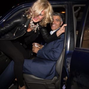 The real Alison Jackson with George Clooney by Alison Jackson, the photographer climbing out of a car over a george clooney lookalike