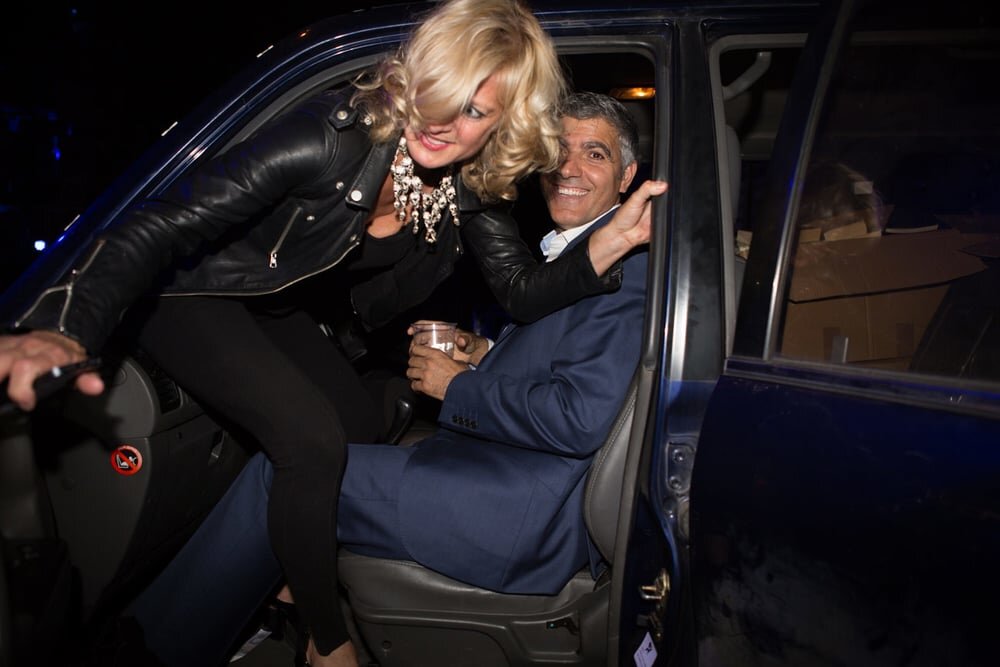 The real Alison Jackson with George Clooney by Alison Jackson, the photographer climbing out of a car over a george clooney lookalike