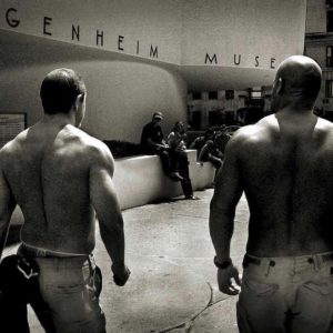 Coming-out of Guggenheim by Andreas H. Bitesnich, two topless men walking in front of the museum