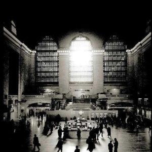 Grand Central Terminal by Andreas H. Bitesnich, people walking through the station concourse with the sun shining through the windows