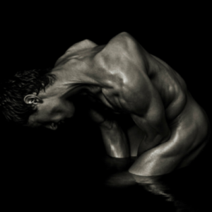 Michael - Milan by Andreas H. Bitesnich, male model standing in water, crouching and twisting his body