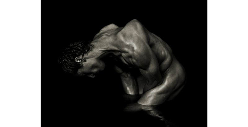 Michael - Milan by Andreas H. Bitesnich, male model standing in water, crouching and twisting his body