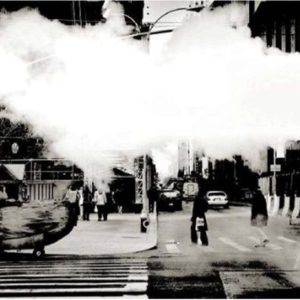 Street Scene #685 by Andreas H. Bitesnich, people crossing the street, white smoke covering the scene