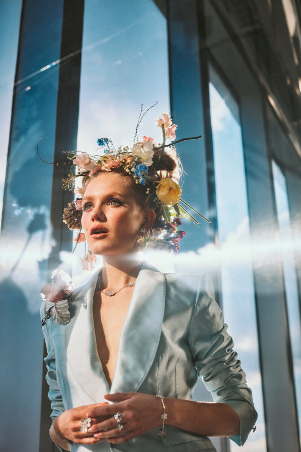 Hadley Robinson III by Guy Aroch, the actress in a light blue jacket and flowercrown