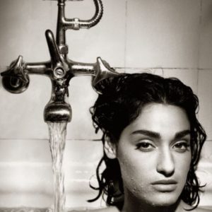 Yvette by Albert Watson, the model sitting in a bathtub next to the running faucet