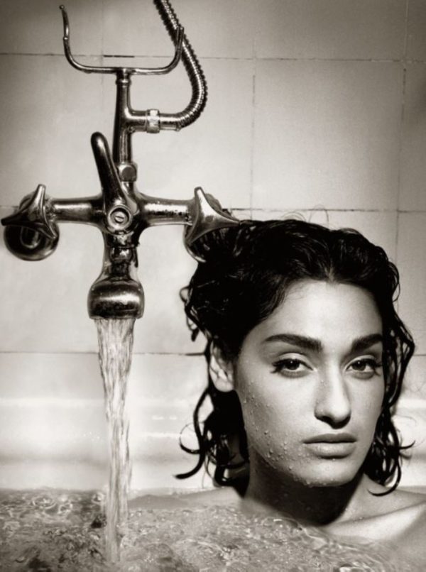 Yvette by Albert Watson, the model sitting in a bathtub next to the running faucet