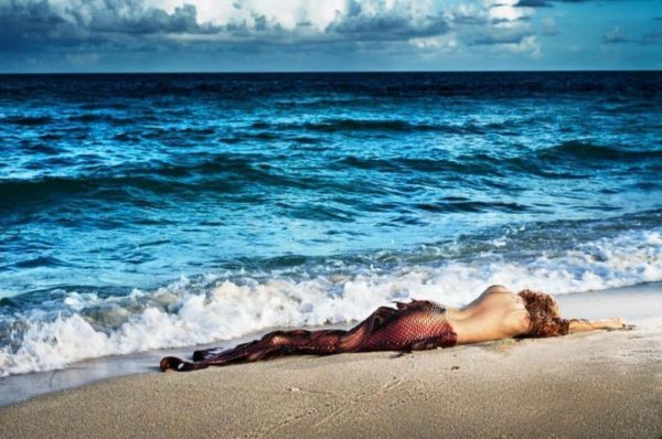 Mermaid in paradise by David Drebin, memaid lying at the beach