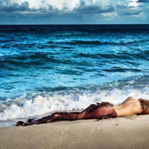 Mermaid in paradise by David Drebin, memaid lying at the beach