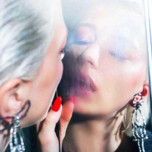 Smoke and mirrors by David Drebin, model with white hair and red nails breathing at an