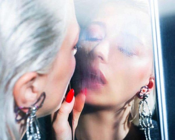 Smoke and mirrors by David Drebin, model with white hair and red nails breathing at a fogged up mirror