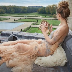 Chateau Fontainbleau by Iris Brosch, model in transparent gown sitting on a castles roof with a mirror, looking out over the baroque garden