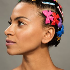 Adeline, Afropunk by Marc Baptiste, portrait of black model wearing cornrows with colorful plastic hairclips