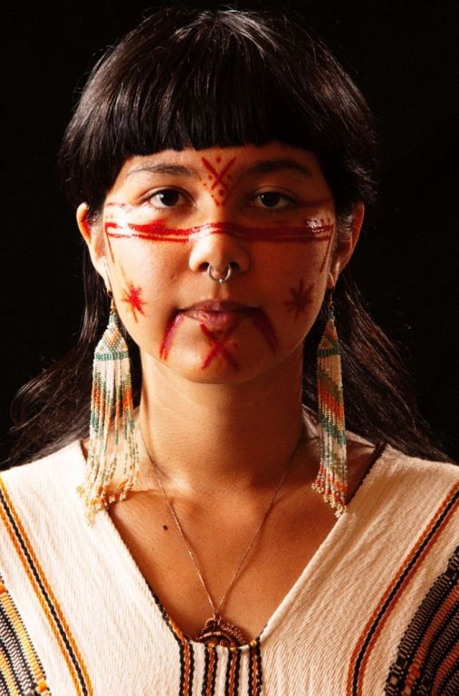Aniwa Gathering II by Marc Baptiste, portrait of indigenous person with red face markings and traditional jewelery and dress