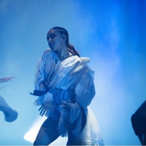 FKA Twigs by Marc Baptiste, portraqit of the singer in a white ruffle dress and cornrows while performing qt the 2019 afropunk festival in London
