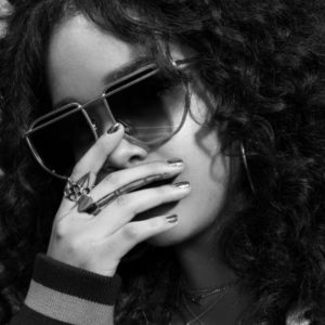 H.E.R., Afropunk by Marc Baptiste, black and white closeup portrait of the singer wearing sungalsses and rings