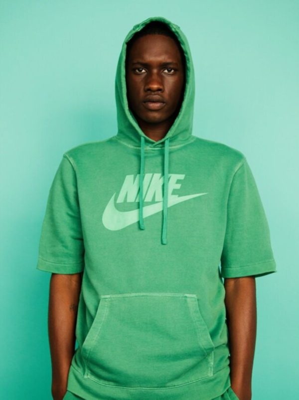 Untitled IX by Marc Baptiste, portrait of male model wearing a green nike sweater in front of a green background