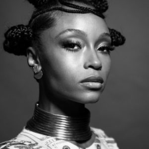 Yaya Decosta by Mark Seliger, black and white portrait of the actress and model in native hairstyle and necklace