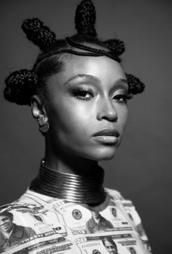 Yaya Decosta by Mark Seliger, black and white portrait of the actress and model in native hairstyle and necklace