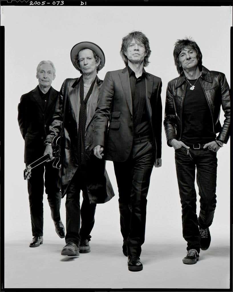The Rolling Stones by Mark Seliger, black and white portrait of the band walking towards the camera